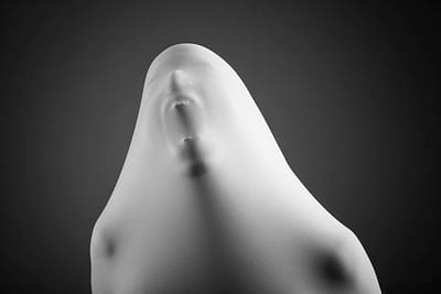 A face pressed against stretched white fabric, mouth open, against the dark